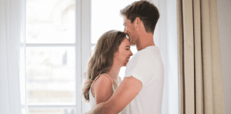 Man and woman embracing.