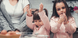 Two girls baking with a woman.