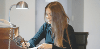 A woman writing a letter.