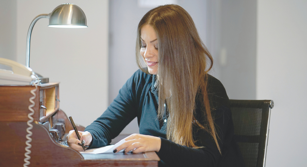 A woman writing a letter.