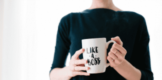 A woman holding a mug that says "Like a Boss."
