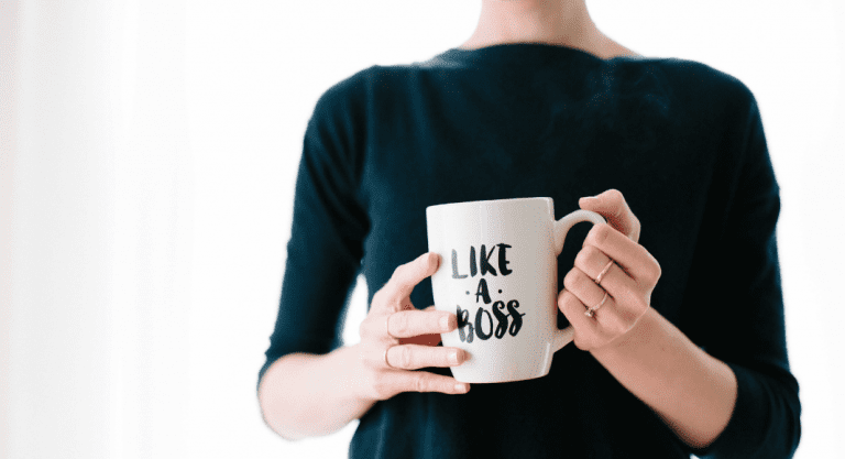 A woman holding a mug that says 