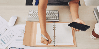 Woman at a desk filling in a calendar.