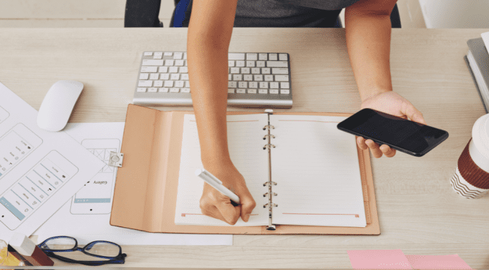 Woman at a desk filling in a calendar.