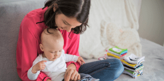 A mother reading to her baby.