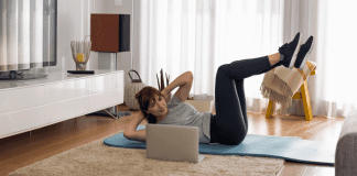 A woman doing an at-home workout in her living room.