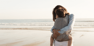Do You Ever Feel Alone? A woman holding a toddler on the beach.