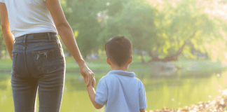 A mom holding hands with her son.
