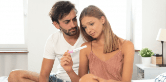 A couple seeing the results of a pregnancy test.