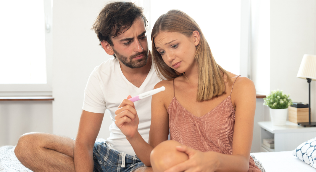 A couple seeing the results of a pregnancy test.
