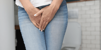 A woman holding her crotch because she has to pee.