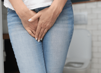 A woman holding her crotch because she has to pee.