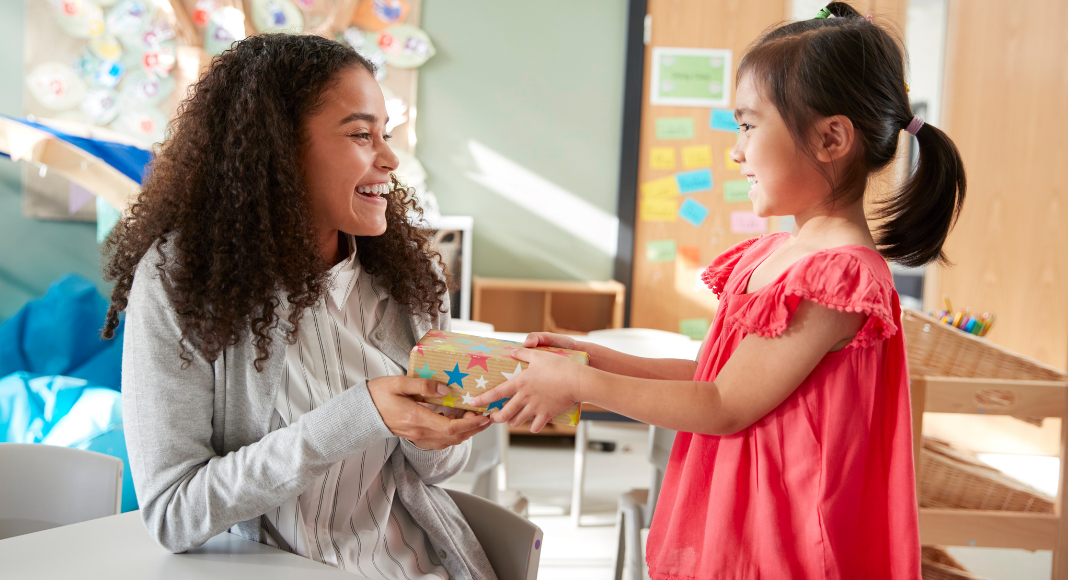 A child giving a teacher