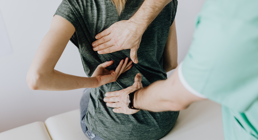 A chiropractor working with a patient.