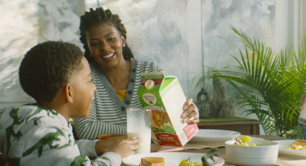 A mom pouring a glass of Organic Valley milk.