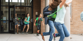 Kids running out of a school building.