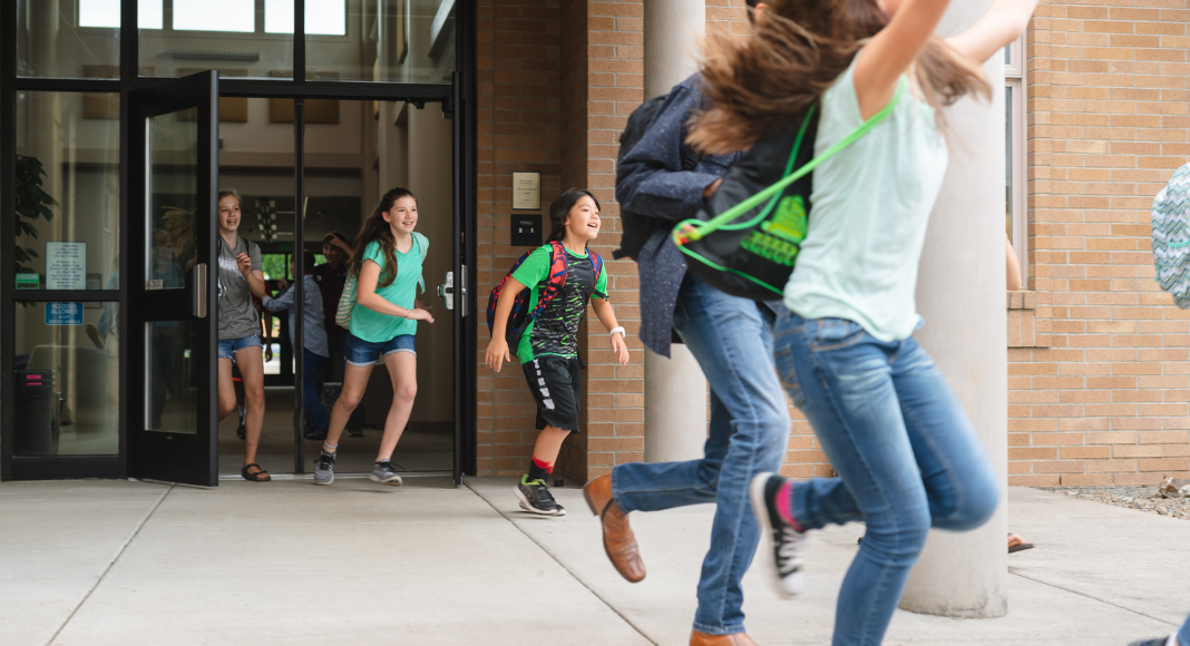 Kids running out of a school building.