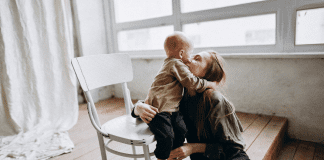 A toddler hugging his mom.