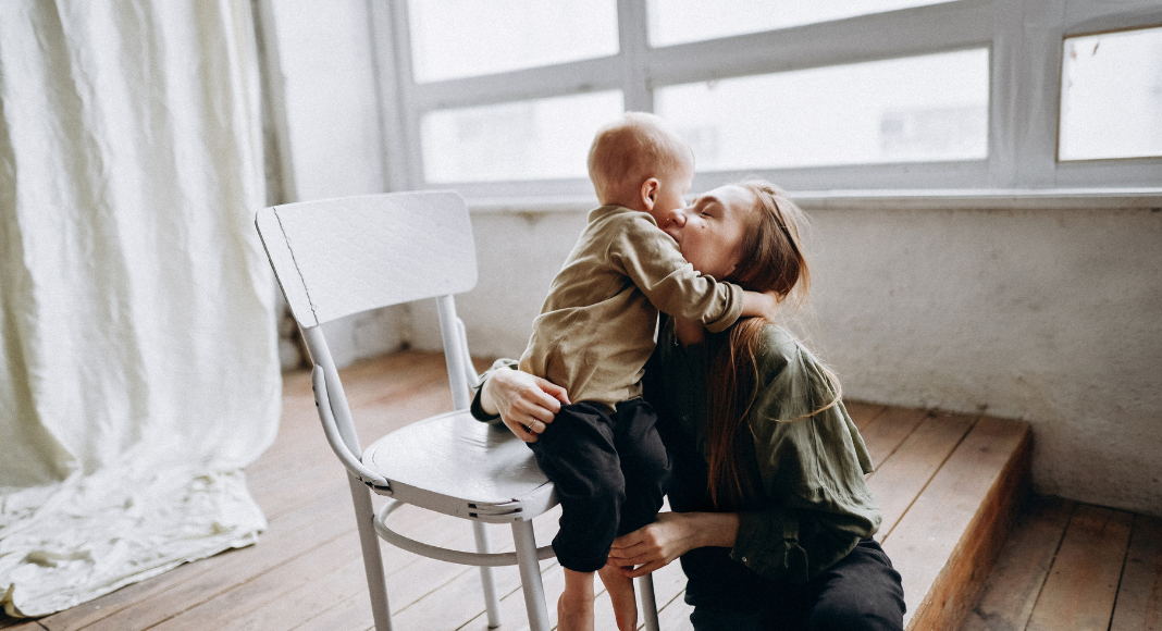 A toddler hugging his mom.
