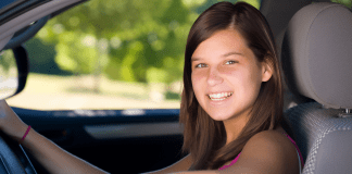A teen driving a car.
