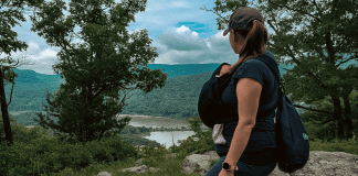 A mom hiking with a baby carrier.