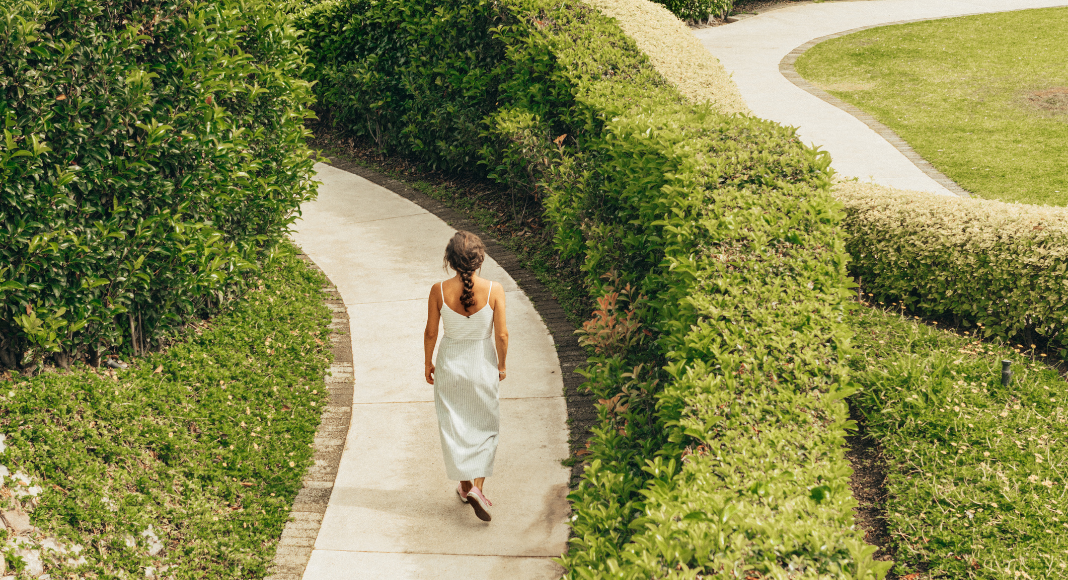 A woman walking through a maze.