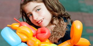 Balloon Animals: A Random Act of Kindness A girl holding a bunch of balloon animals.