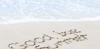 Goodbye summer written in the sand.