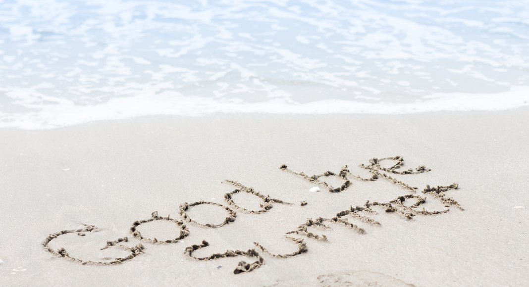 Goodbye summer written in the sand.