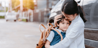 A mother holding her son before school.
