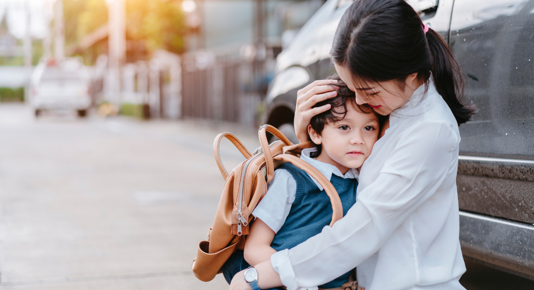 A mother holding her son before school.