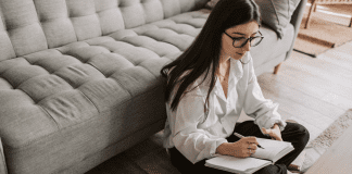 A woman writing in a journal.