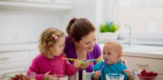 A mother feeding her children.