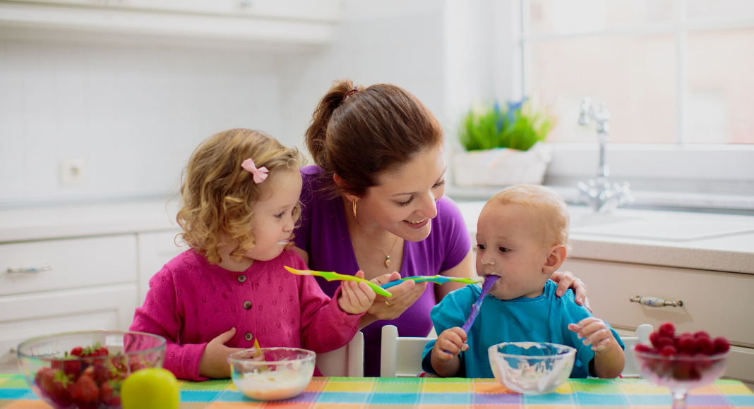 A mother feeding her children.