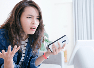 A frustrated woman holding a phone.