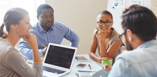 A team at a business meeting using business lingo.