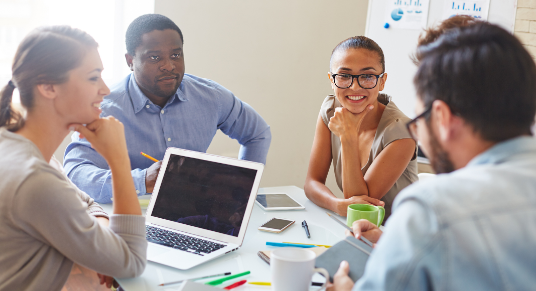 A team at a business meeting using business lingo.