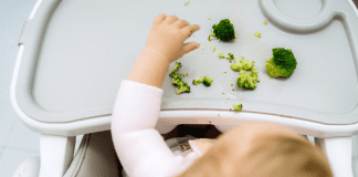 10 Tips for Baby-Led Weaning A baby eating broccoli.