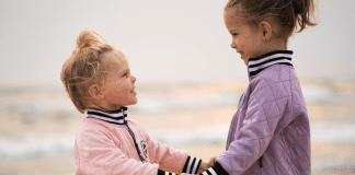 Am I Too Tough on My Firstborn? Sisters holding hands.