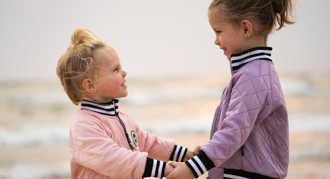 Sisters holding hands.