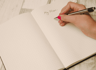 Writing down a plan for the new year in a journal.