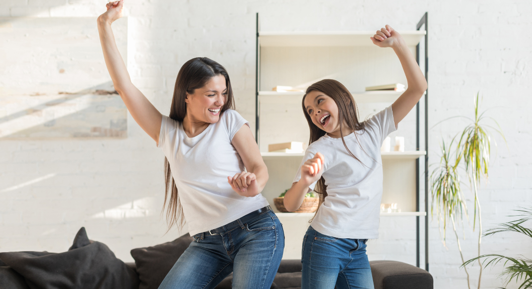 Mom and daughter dancing.