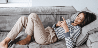 Westchester County Mom Top 10 Posts of 2022 A woman reading Westchester County Mom on her phone.