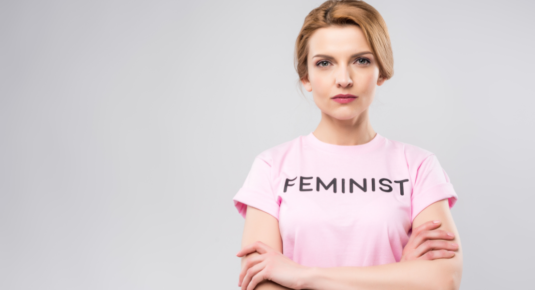 A woman wearing a "feminist' t-shirt.