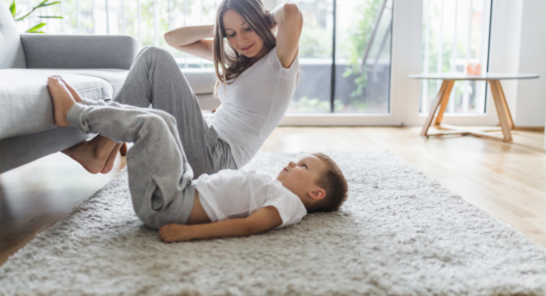 A mom exercising with her young son. 