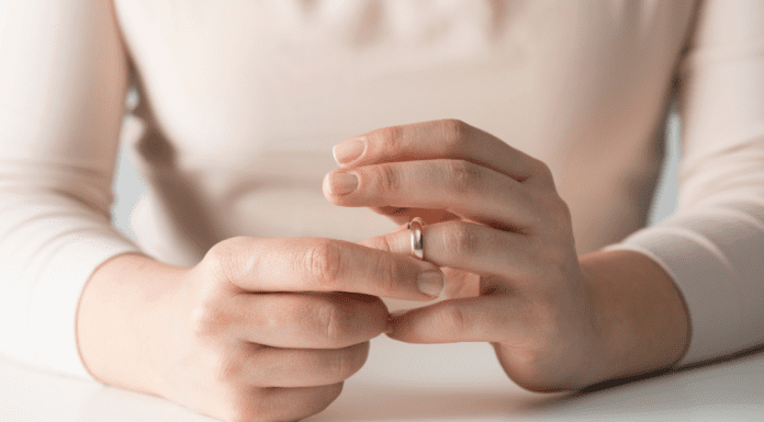 A woman removing her wedding ring.