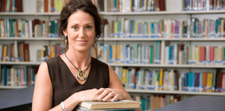 A librarian holding a stack of books.