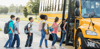 Uplifting the Underdog: Teaching Our Kids to Be Kind Children lined up to get on a school bus.