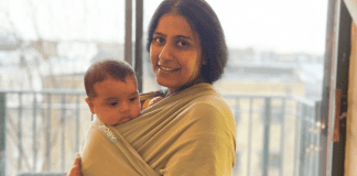 M is for Mama, M is for Mental Health A mother holding her baby in a carrier.