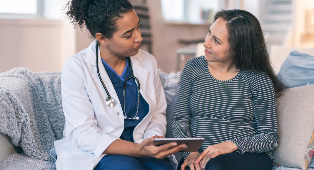 A woman speaking with a doctor.